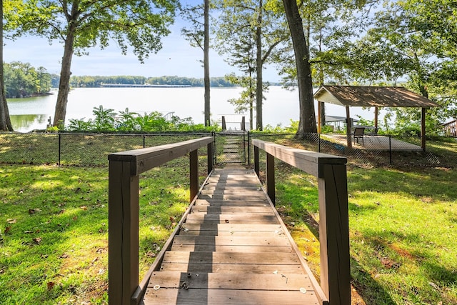 exterior space with a water view and a lawn