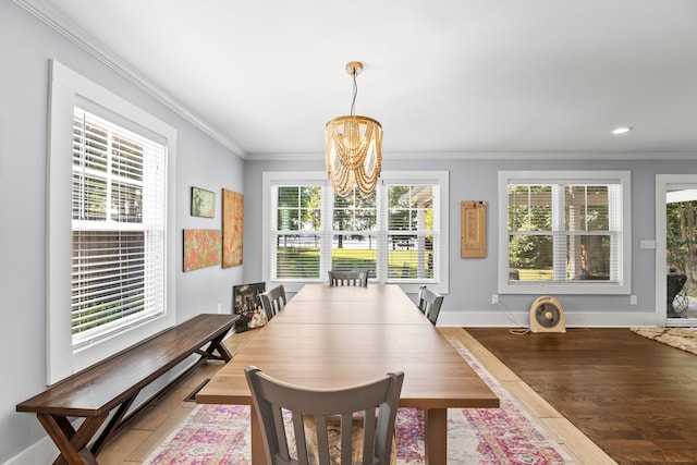 dining room featuring hardwood / wood-style floors, a notable chandelier, and ornamental molding