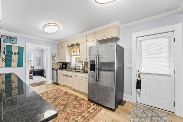 kitchen featuring light wood-type flooring, cream cabinetry, appliances with stainless steel finishes, and crown molding