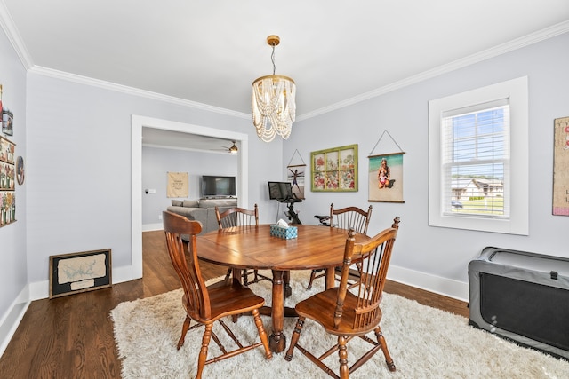 dining room with ornamental molding and dark hardwood / wood-style floors