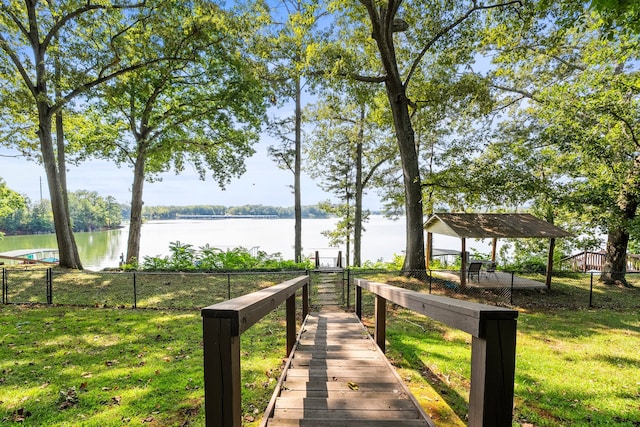 view of community with a water view and a yard