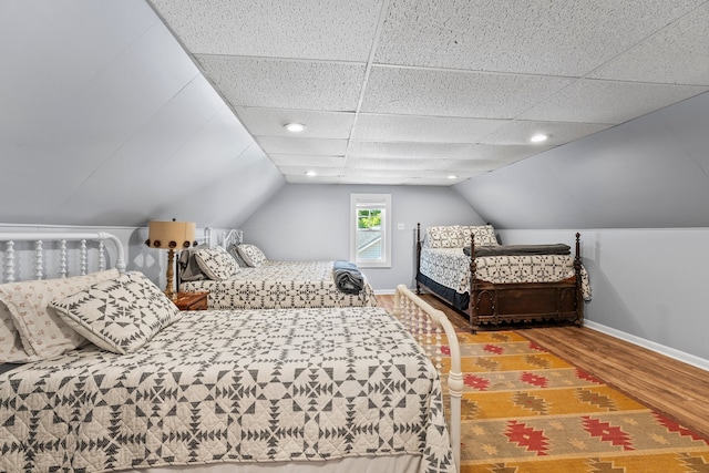 bedroom featuring vaulted ceiling and wood-type flooring