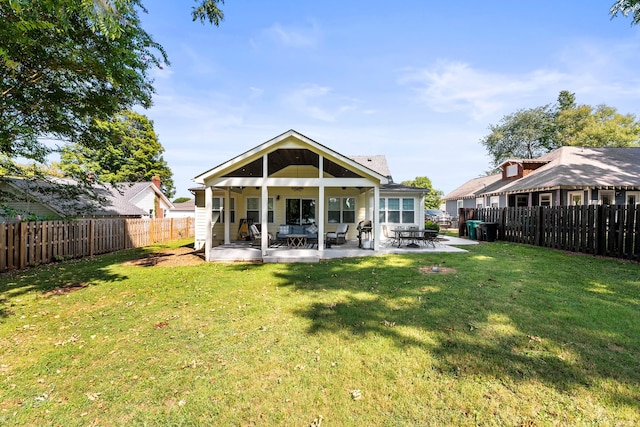 rear view of property with a yard and a patio