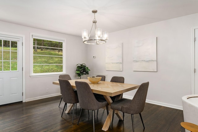 dining space with a chandelier, baseboards, and dark wood-style flooring