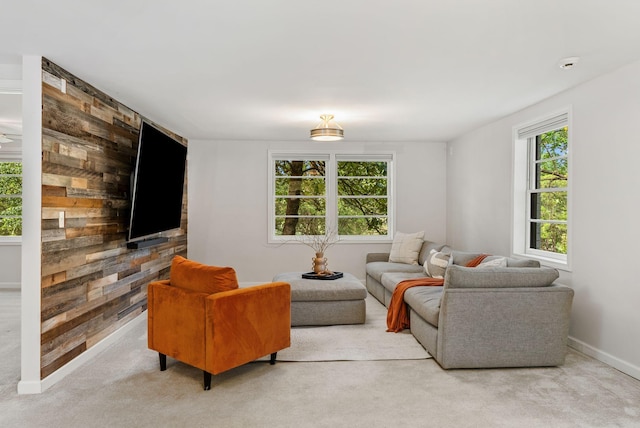 living room with baseboards and light carpet