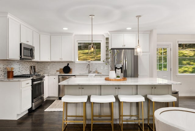 kitchen featuring white cabinets, backsplash, and stainless steel appliances