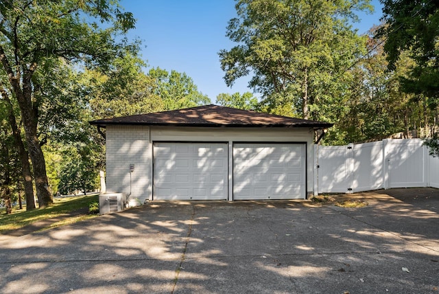 detached garage with fence and a gate