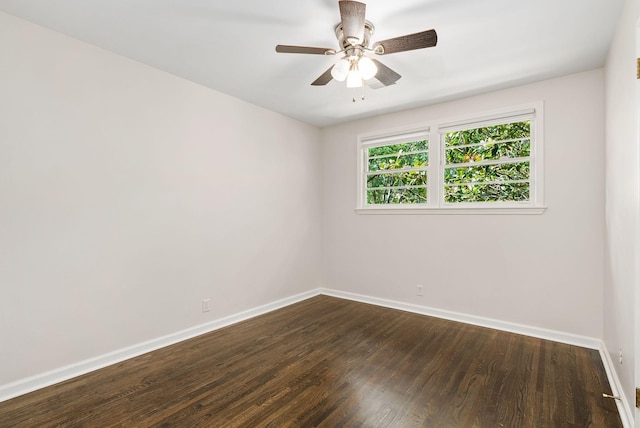 unfurnished room featuring dark wood-style floors, baseboards, and ceiling fan