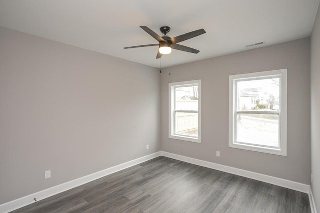 empty room featuring ceiling fan and dark hardwood / wood-style floors