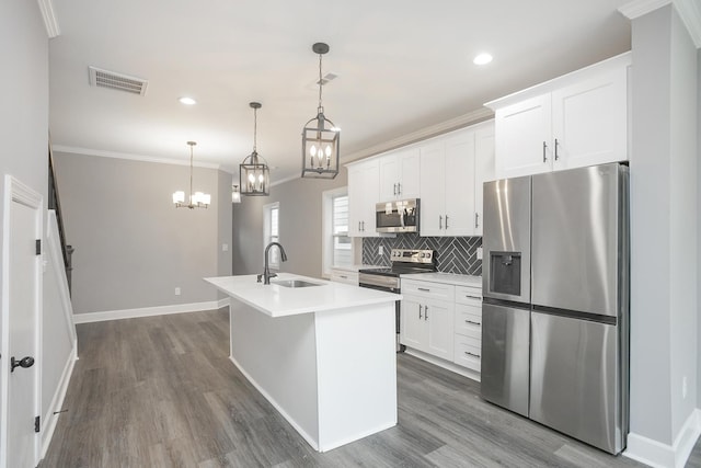 kitchen featuring a kitchen island with sink, white cabinetry, stainless steel appliances, dark hardwood / wood-style flooring, and sink