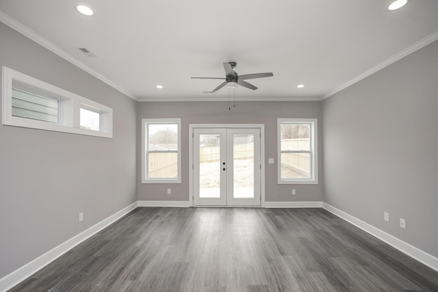 spare room featuring plenty of natural light, dark hardwood / wood-style flooring, ceiling fan, and french doors