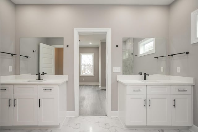 bathroom with vanity, walk in shower, wood-type flooring, and a healthy amount of sunlight