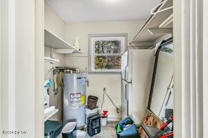 utility room featuring electric water heater