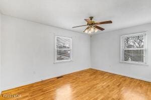 unfurnished room featuring wood finished floors and ceiling fan