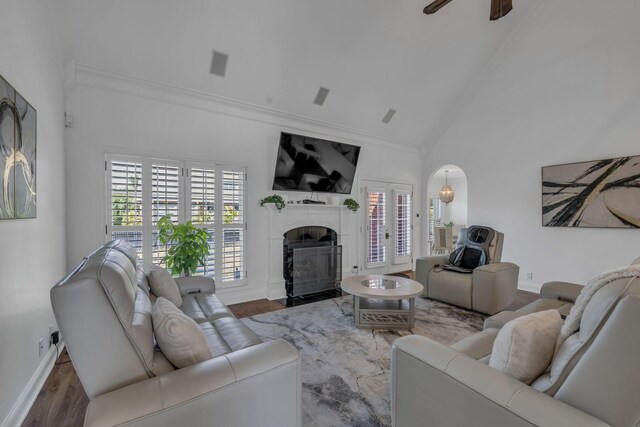 living room with high vaulted ceiling, ceiling fan, wood-type flooring, and ornamental molding