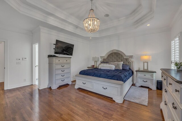 bedroom with a notable chandelier, a tray ceiling, dark hardwood / wood-style flooring, and crown molding