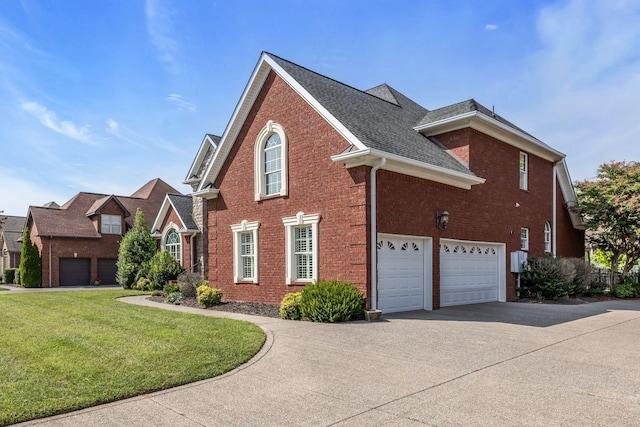 view of side of property featuring brick siding, a shingled roof, a lawn, a garage, and driveway