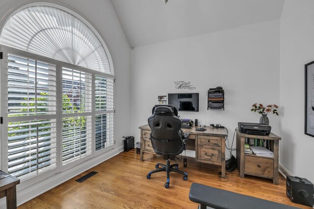 office area with wood-type flooring and vaulted ceiling