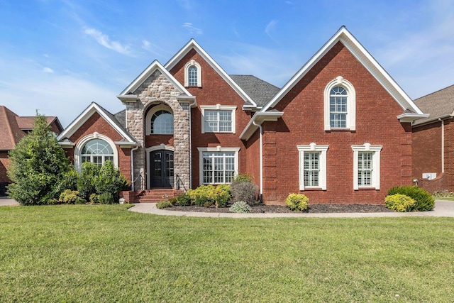 traditional-style house with brick siding and a front yard