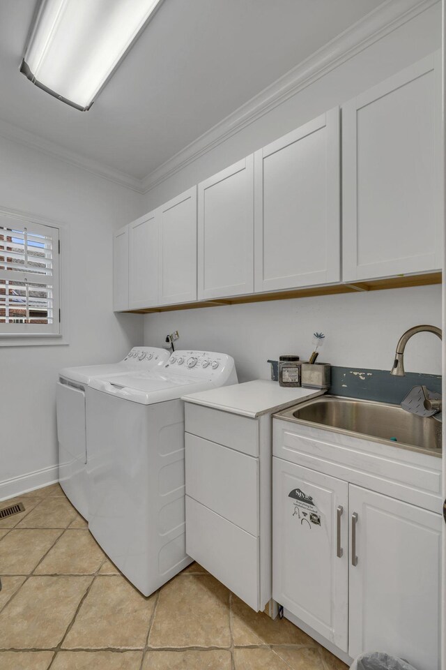 laundry room featuring independent washer and dryer, crown molding, cabinets, and sink