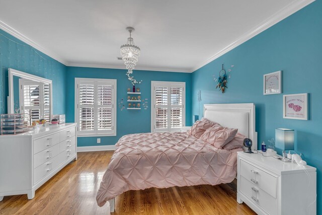 bedroom with crown molding, an inviting chandelier, and light wood-type flooring