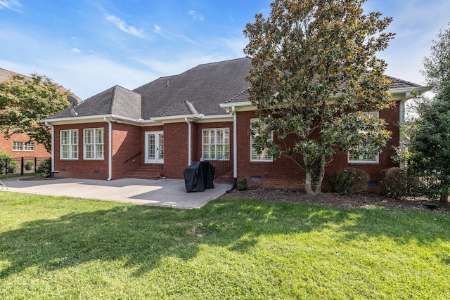 rear view of house with a patio area and a lawn