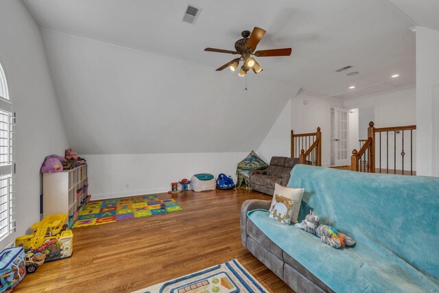 interior space with lofted ceiling, a healthy amount of sunlight, ceiling fan, and wood-type flooring