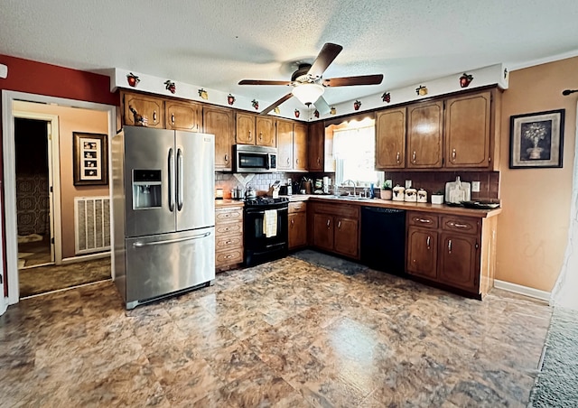 kitchen with a textured ceiling, black appliances, sink, ceiling fan, and decorative backsplash