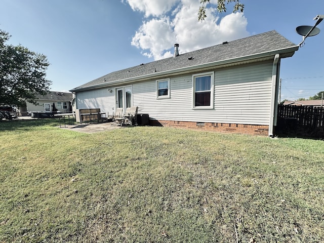 rear view of property with a yard and a patio