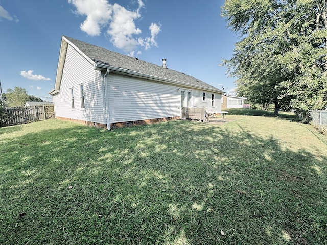 rear view of house with a lawn