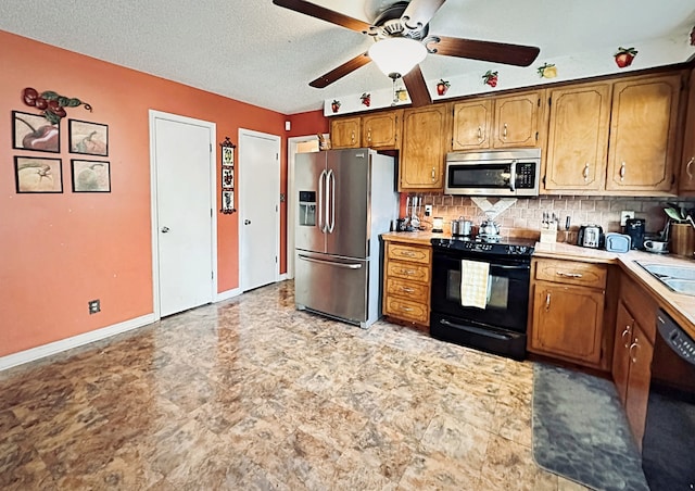 kitchen with a textured ceiling, black appliances, sink, decorative backsplash, and ceiling fan