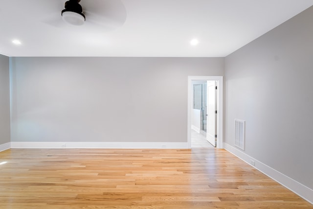 unfurnished room with ceiling fan and light wood-type flooring