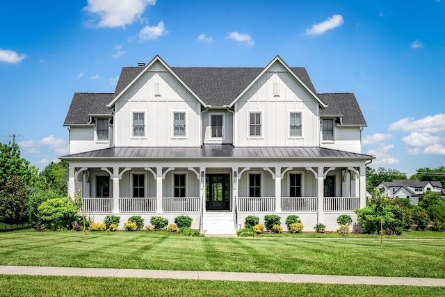 modern inspired farmhouse with a front lawn and a porch