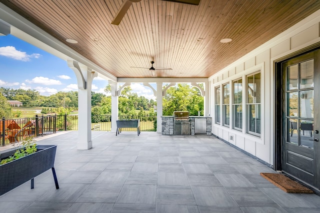 view of patio with ceiling fan and an outdoor kitchen