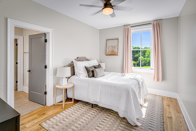 bedroom with light hardwood / wood-style flooring and ceiling fan