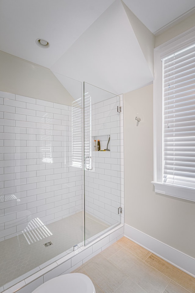 bathroom featuring a shower with door