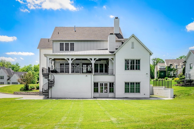 rear view of house featuring a lawn