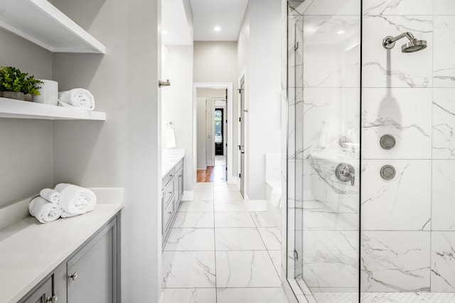 bathroom with a shower with door and vanity