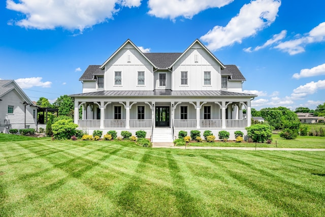 view of front of property featuring a front yard and covered porch