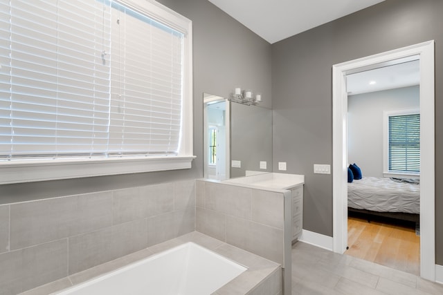 bathroom with a tub and hardwood / wood-style flooring