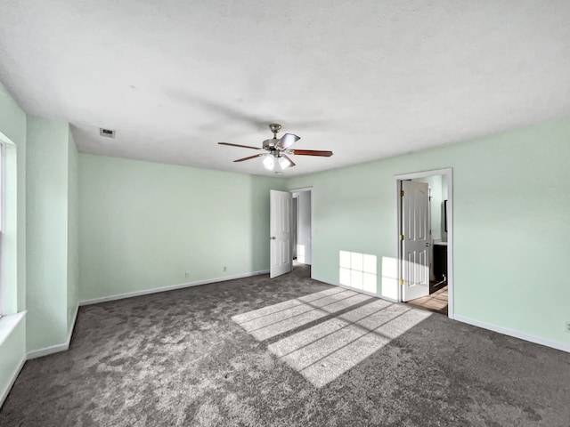 carpeted spare room with ceiling fan