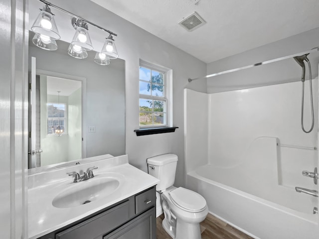 full bathroom featuring vanity, toilet, tub / shower combination, and hardwood / wood-style flooring