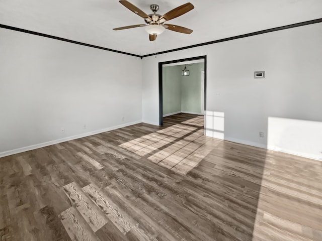 unfurnished room with ornamental molding, hardwood / wood-style flooring, and ceiling fan