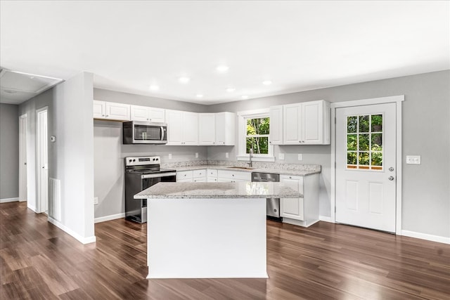 kitchen featuring appliances with stainless steel finishes, white cabinetry, and dark hardwood / wood-style flooring