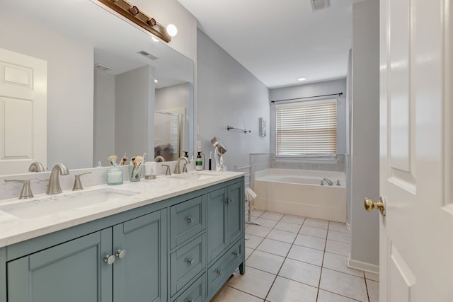 bathroom with vanity, tile patterned flooring, and a bathtub