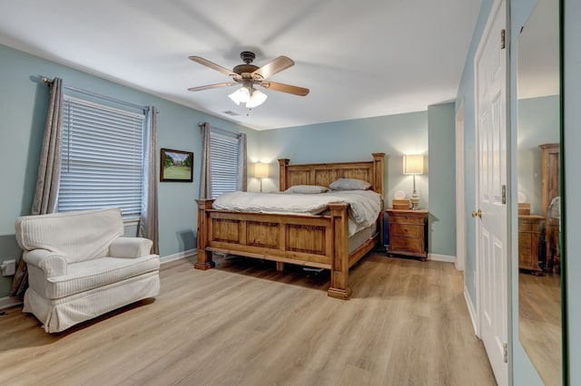 bedroom with light wood-type flooring and ceiling fan