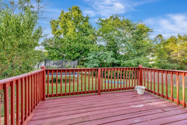 deck featuring a yard and a trampoline