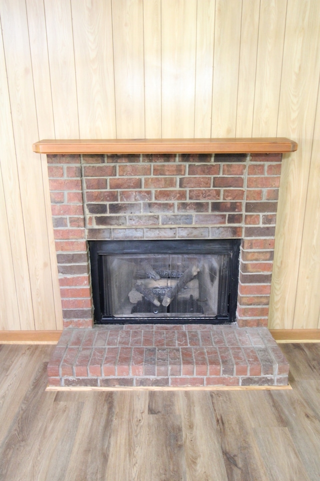 room details with a brick fireplace and wood-type flooring