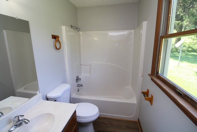 full bathroom featuring vanity, toilet, hardwood / wood-style floors, and bathing tub / shower combination