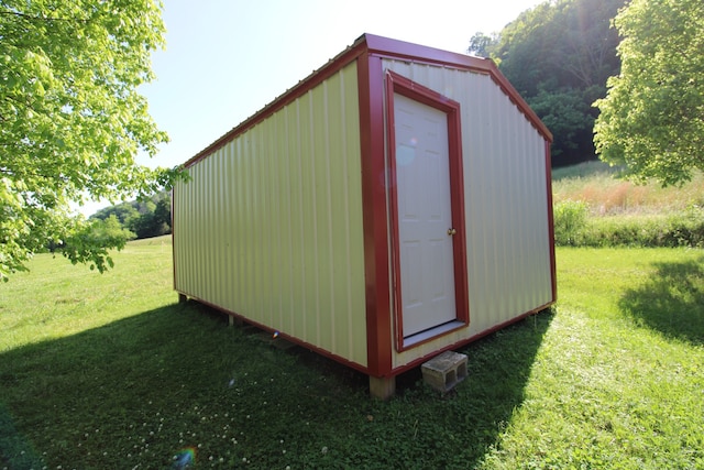 view of outbuilding with a yard